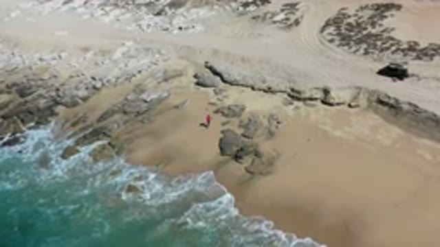 LOS CABOS MEXICO-2020: Waves Playing At Sea Shore Showing Rocky Beach And Person