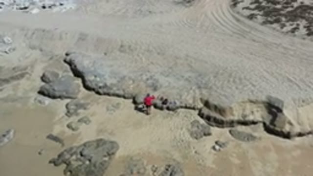 LOS CABOS MEXICO-2020: Aerial View Of A Man In A Red Shirt On The Beach
