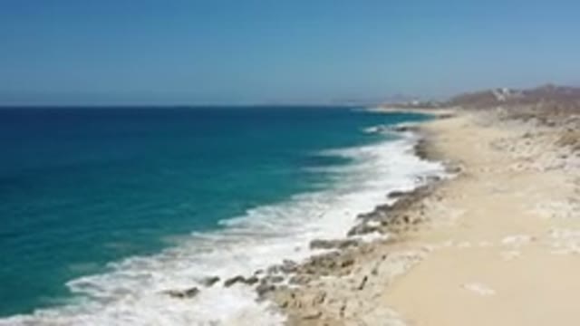 LOS CABOS MEXICO-2020: Crashing Blue Waves Across A Rocky Coastline And White