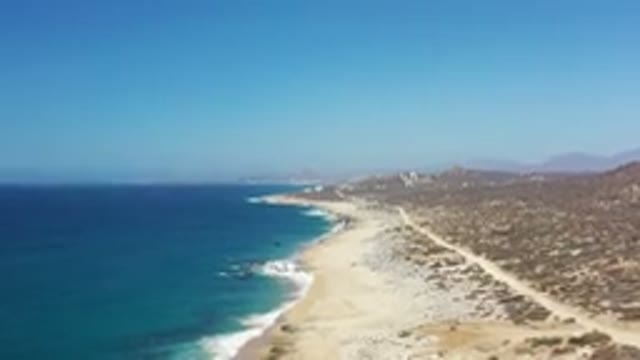 LOS CABOS MEXICO-2020: Ocean Waves Crashing Onto Sandy Deserted Beach View From