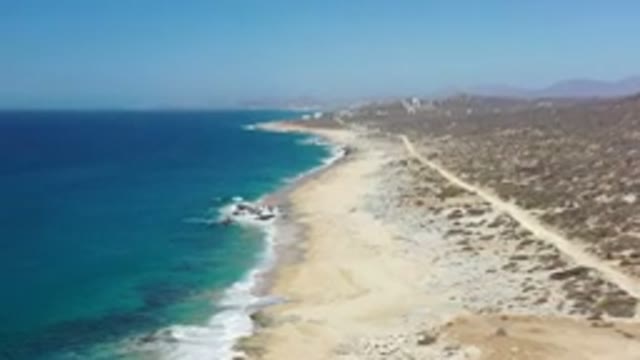 LOS CABOS MEXICO-2020: Moving Overhead Drone View Of The Ocean And A Sandy Beach
