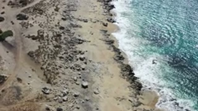 LOS CABOS MEXICO-2020: Calm Waves Of A Bright Blue Sea Reaching The Edge Of A