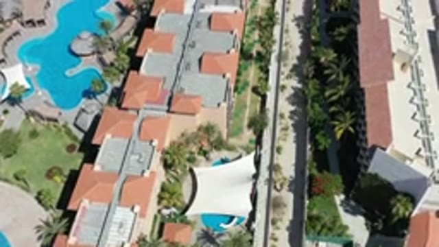 LOS CABOS MEXICO-2020: Aerial View Of Buildings With Sand And Trees On A Clear