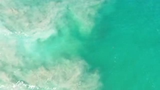LOS CABOS MEXICO-2020: Ocean Water Swirling in Tide Pools of Sand and Sediment