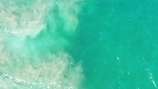 LOS CABOS MEXICO-2020: Green Wavy Water Mixes With Nearby Sand