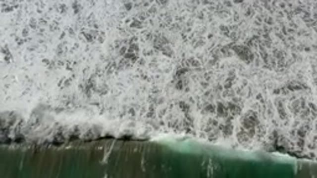 LOS CABOS MEXICO-2020: Foamy White Waves Erasing Scattering Retracting On Sandy Shore