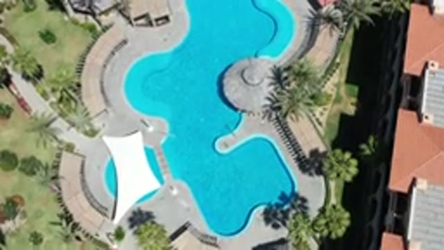 LOS CABOS MEXICO-2020: Aerial View Of Green Space And Pool With Rooftops And