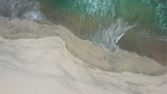 LOS CABOS MEXICO-2020: Straight Top View Of A Wide White Bubble Wave On To The