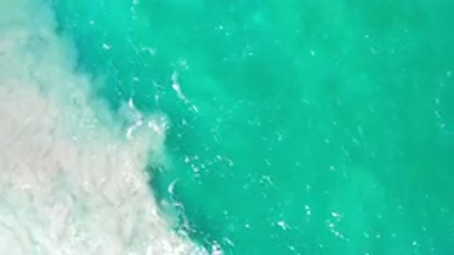 LOS CABOS MEXICO-2020: Aqua Seafoam Sun-Dappled Waters At The Base Of Rocky Shore