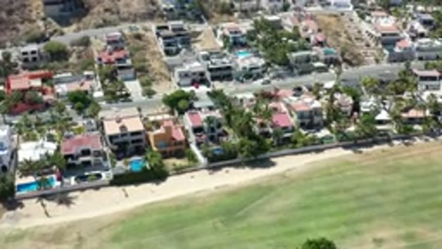 LOS CABOS MEXICO-2020: Camera Flies Over Residential Homes With Pools Behind