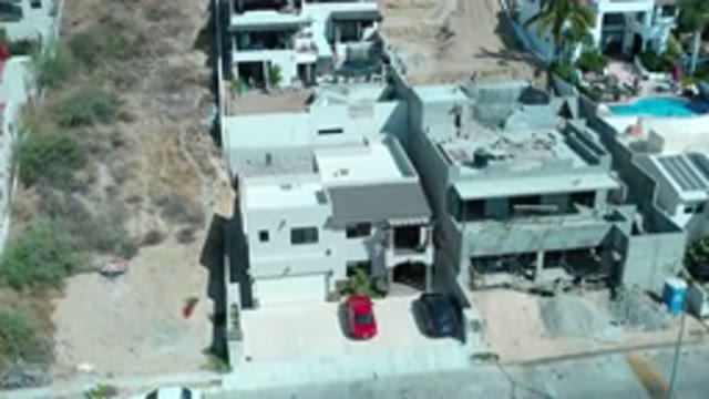 LOS CABOS MEXICO-2020: An Aerial View Of Homes Built On The Side Of A Hilly