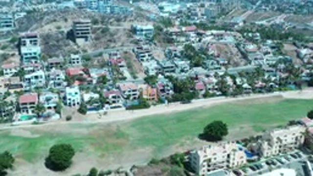 LOS CABOS MEXICO-2020: Neighborhood Apartments Trees Hovering With Sandy Areas