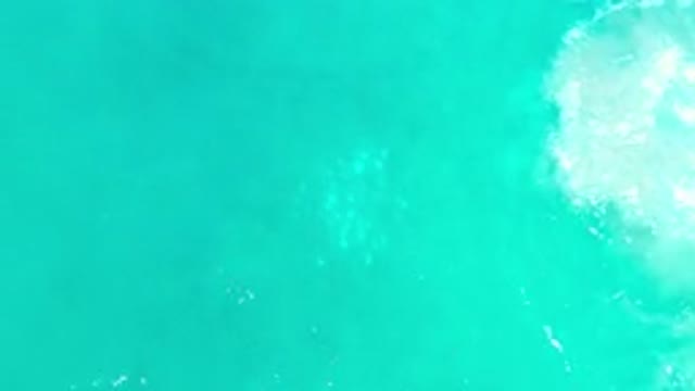LOS CABOS MEXICO-2020: Light Green Shaded Wavy Water With Sunlight Reflection On
