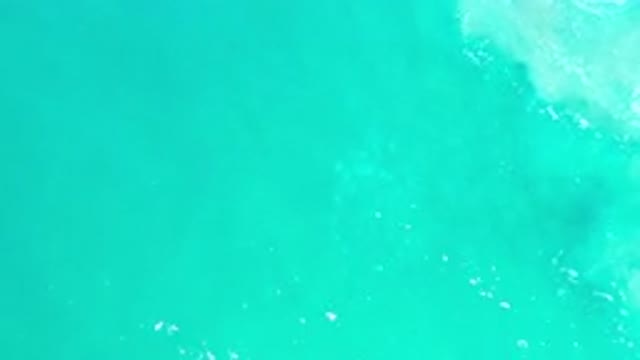 LOS CABOS MEXICO-2020: Overhead Pan Over Bright Teal Ocean Water Moving