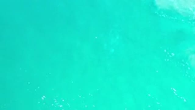 LOS CABOS MEXICO-2020: Rippling Deep Blue Wave Moving Into Light Green Sea Water