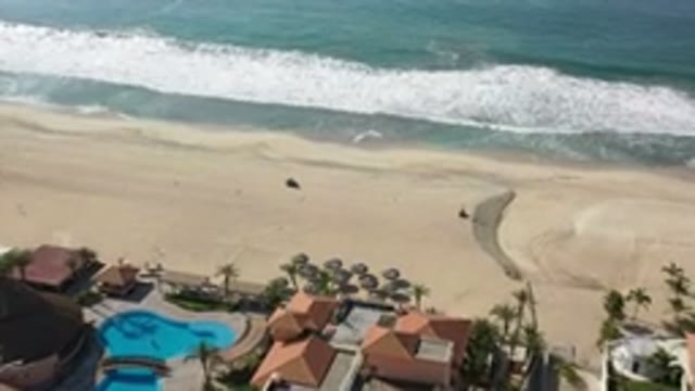 LOS CABOS MEXICO-2020: Vehicle Drives Behind Houses On Beach Near Ocean