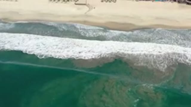 LOS CABOS MEXICO-2020: Looking Over The Ocean As The Waves Approach A Town