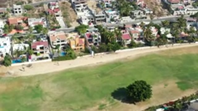 LOS CABOS MEXICO-2020: The City With Many Villas And Greenish Land With Vehicles