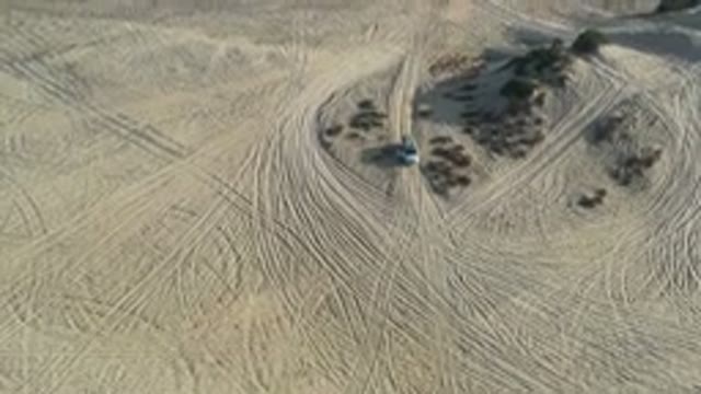 LOS CABOS MEXICO-2020: An Aerial View Of A Desert With A Single Car And Some Trees