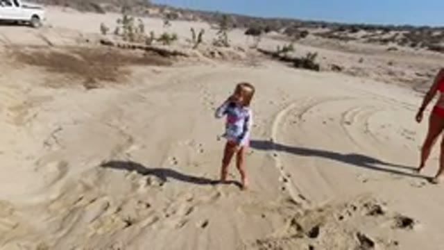 LOS CABOS MEXICO-2020: Mother And Daughter Walking And Making Footprints On A