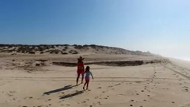 LOS CABOS MEXICO-2020: Adult And Child Walking On A Beach