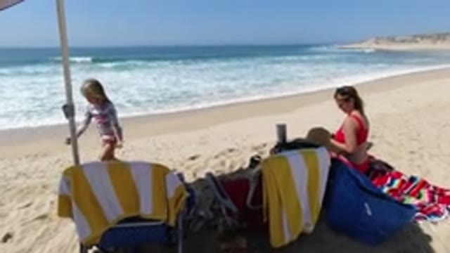 LOS CABOS MEXICO-2020: A Woman And Child In A Beach Hut In Front Of The Blue Sea