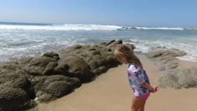 LOS CABOS MEXICO-2020: Girl In A White Shirt Looking At The Beach Sand While The