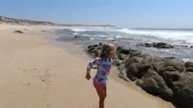 LOS CABOS MEXICO-2020: A Little Girl Playing With Sea Water At The Beach