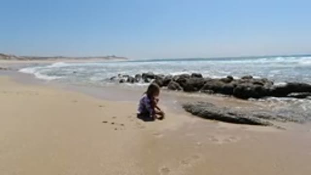 LOS CABOS MEXICO-2020: Child Playing With Sand In A Beautiful Beach Next To
