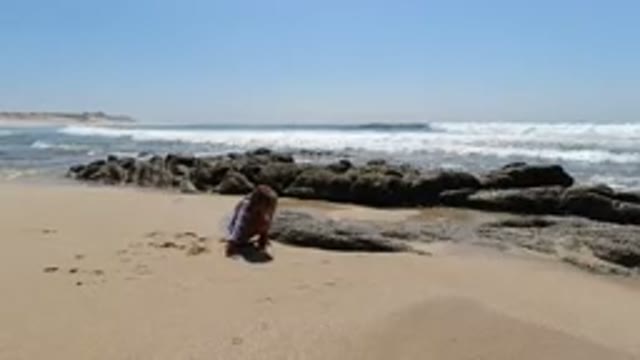 LOS CABOS MEXICO-2020: Child Playing With Sand In A Rocky Beach With The Clear