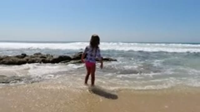 LOS CABOS MEXICO-2020: Child On The Beach Next To The Rocks Happy To See The