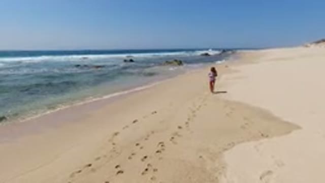 LOS CABOS MEXICO-2020: Young Girl Walking On The Wet Part Of The Beach That Has