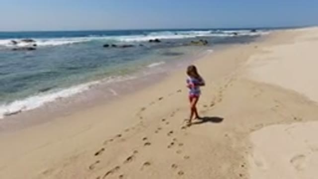 LOS CABOS MEXICO-2020: Girl Following Footsteps On The Beach