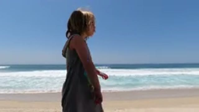 LOS CABOS MEXICO-2020: Young Girl Swinging Her Arms on Beach