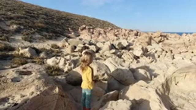 LOS CABOS MEXICO-2020: Little Girl On A Rock Climbing Adventure Sees Something