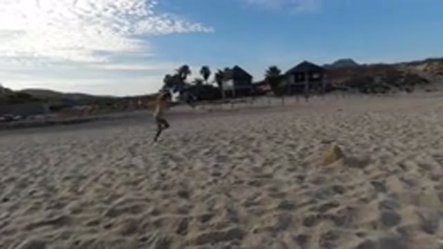 LOS CABOS MEXICO-2020: Child Running And Having Fun In The Beach Playing With A Kite