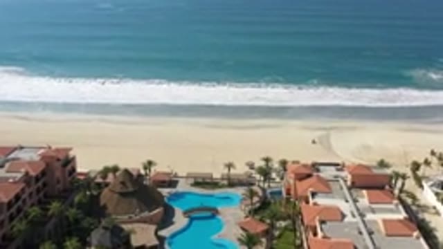 LOS CABOS MEXICO-2020: Villa Pool Overlooks White Crashing Waves Flowing Over Sand