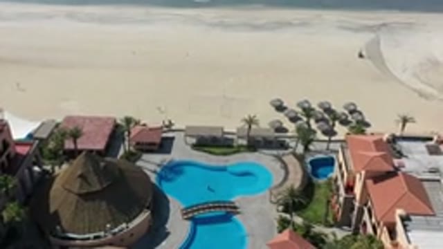 LOS CABOS MEXICO-2020: A Swimming Pool Near Sandy Beach With Palm Trees