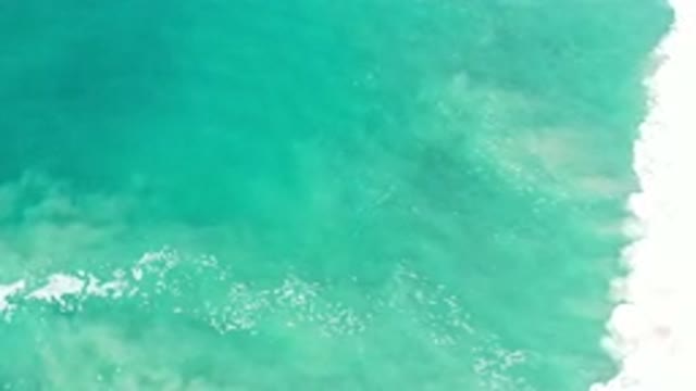 LOS CABOS MEXICO-2020: Teal Colored Ocean Lapping a Shore