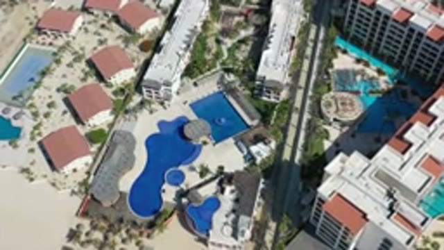 LOS CABOS MEXICO-2020: Open Pool Hotel Water Sunny Tropical Trees Buildings Sand