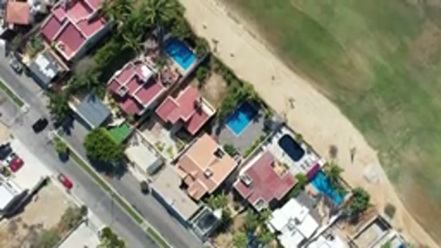 LOS CABOS MEXICO-2020: Top Straight View Of Building Roofs And Green Fields From