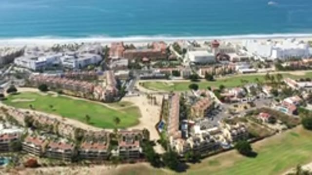 LOS CABOS MEXICO-2020: City With Buildings And Grass Fields Next To Crystal