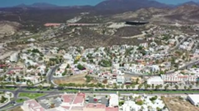 LOS CABOS MEXICO-2020: Highway Of Rushing Cars Below Mansion Filled Hills In A