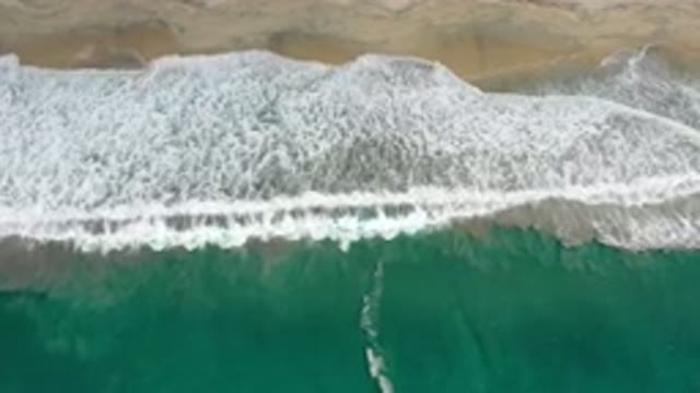 LOS CABOS MEXICO-2020: Green Ocean Water Waves Crash Into White Foam As They