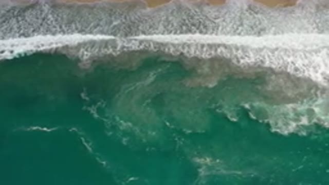 LOS CABOS MEXICO-2020: Crashing Foamy Sea Bubbles Hitting The Beach Sand