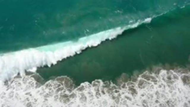 LOS CABOS MEXICO-2020: Green Ocean Waves Crash Into Rocks
