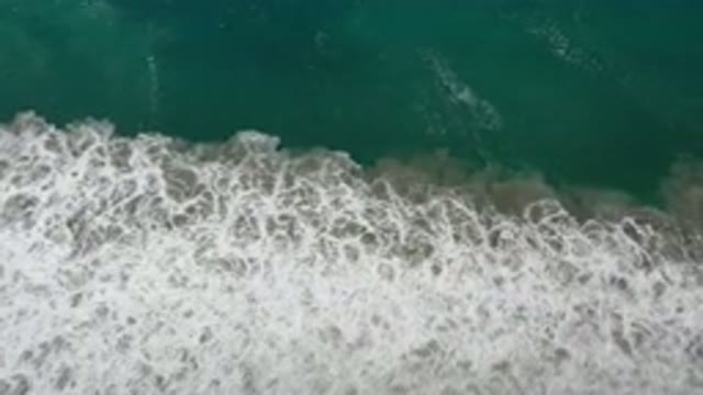 LOS CABOS MEXICO-2020: Waves Crossing Sand At Beach With Green Water And White Foam