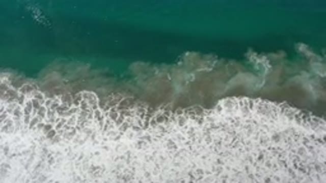 LOS CABOS MEXICO-2020: Bubble Foams On A Green Sea