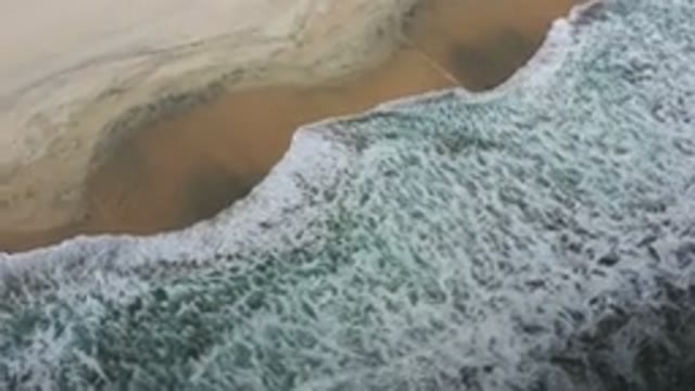 LOS CABOS MEXICO-2020: White Cap Ocean Waves Crash Along The Golden Sand Over