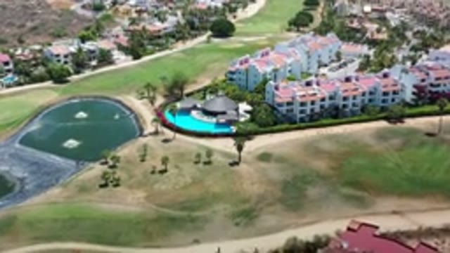 LOS CABOS MEXICO-2020: Aerial View Of A Block Of Houses In A Bright Green Valley